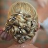 Bride with large curled bun with Grecian style headdress hair pins scattered through the design
