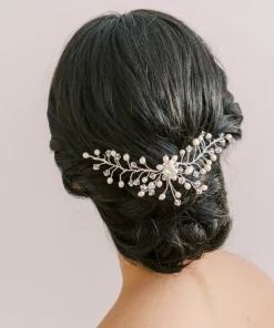 Image showing the back of a womans head, She has dark hair and her hair style is a low bridal bun. She wears a Pearl bridal headpiece in it.