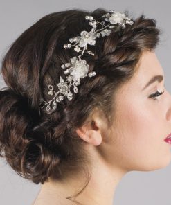flower and pearl bridal hair vine shown on a bride with dark hair set into a side braid, with bun at the nape of the neck