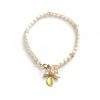 minimalist pearl bracelet with charms on a white background