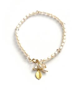 minimalist pearl bracelet with charms on a white background