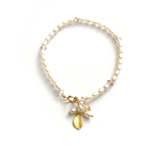 minimalist pearl bracelet with charms on a white background