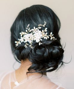 Bride with messy bun and dark hair wearing a wedding comb set to the side behind the ear