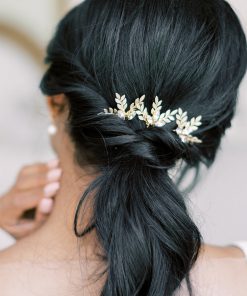 Image of woman with dark hair in a low pony tail wearing 3 leaf hairpins called Crystal Barley Hairpins
