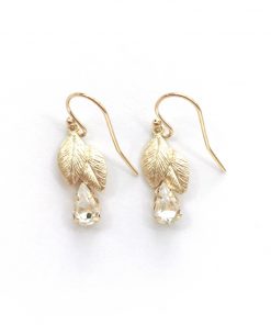 wallflower earrings. Image shows white picture with gold earrings in a leaf shape design on drop hooks with a dangling crystal pear drop at the bottom of each earrings