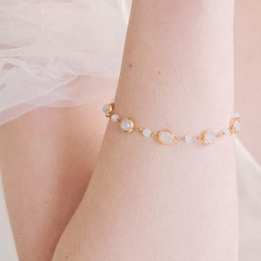 gold crystal link bracelet on a womans arm