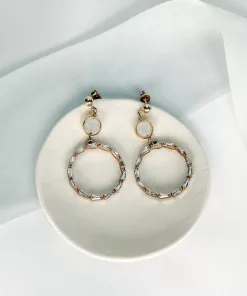 Large Crystal hoop earrings with opal crystals set on a small cream coloured dish, with blue silk ribbon on an ivory fabric background