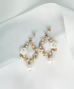 Wreath style botanical pearl earrings with gold stud set on top of a blue silk ribbon draped over an ivory fabric background