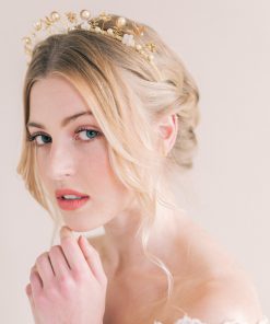 Bride with hand on her chin wearing a wedding crown