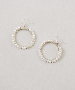 Image showing Freshwater pearl hoop wedding earrings in silver on a beige background.