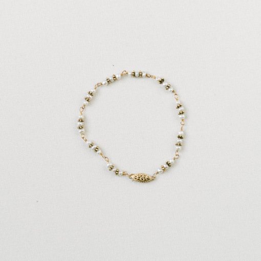 gold freshwater pearl antique style wedding bracelet on a beige background