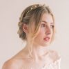 Bride in her wedding dress looking to her left in a bridal crown