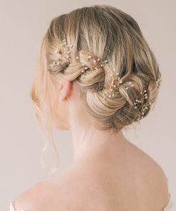 Image shows a bridal hair braid with hair up and small Unique bee and butterfly wedding hair accessory hair pins with pearls decorating the braid.