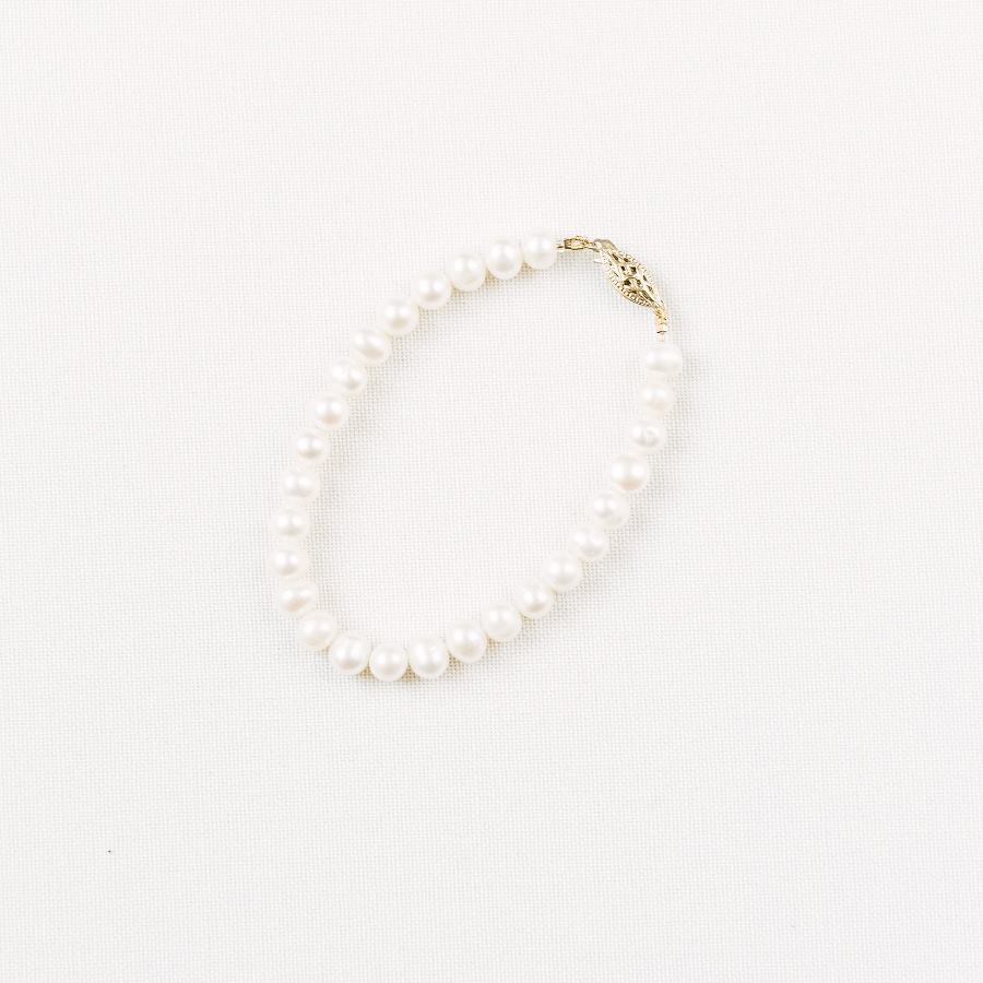traditional real pearl bridal bracelet on beige background