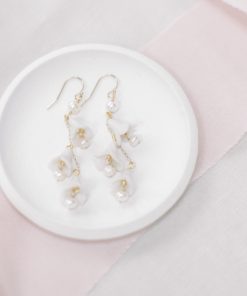 floral drop earrings set on a small white dish