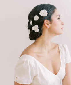 Delilah Hair Pins - Bride looking away from camera with hair up and a scattering of flower pins