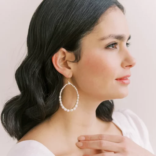 Blythe Pearl Hoop Earrings. Woman with long hair wearing large pearl hoop earrings