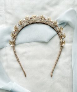 nature inspired Bridal crown with pearls and diamante flat with a blue ribbon background