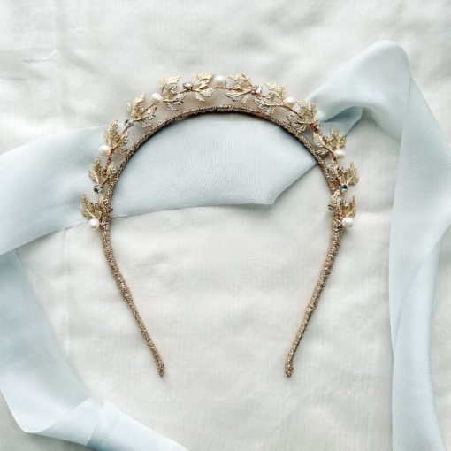 nature inspired Bridal crown with pearls and diamante flat with a blue ribbon background