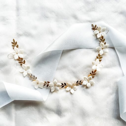flat image of gold leaf and ivory coloured flower hair vine