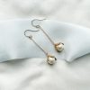 Rosalind pearl drop earrings - image showing long chain style earrings with large pearl drop at the end in gold