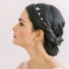 Image of woman with hair up in low bun wearing a star hair vine