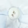 image shows white background with blue silk ribbon draped across and a small ivory clay bowl with Simple modern pearl gold stud earrings