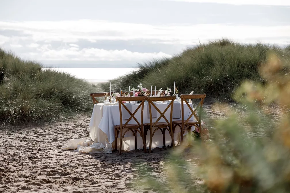 Is it normal to feel anxious planning a wedding? Beach scene with wedding breakfast table set up with chairs