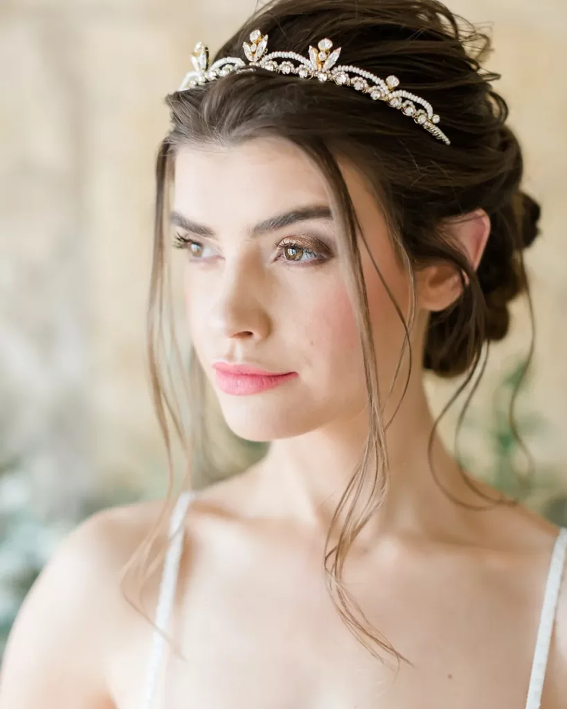 Wedding tiaras and how to wear them. Woman wearing a bridal crown with hair up looking away