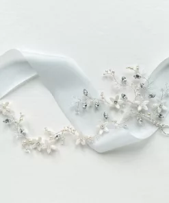 wrap around bridal blossom pearl hair vine resting on a white background with light blue silk ribbon.