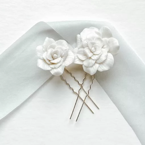wedding handmade floral hair pins in gold set on a white background with light blue silk ribbon.